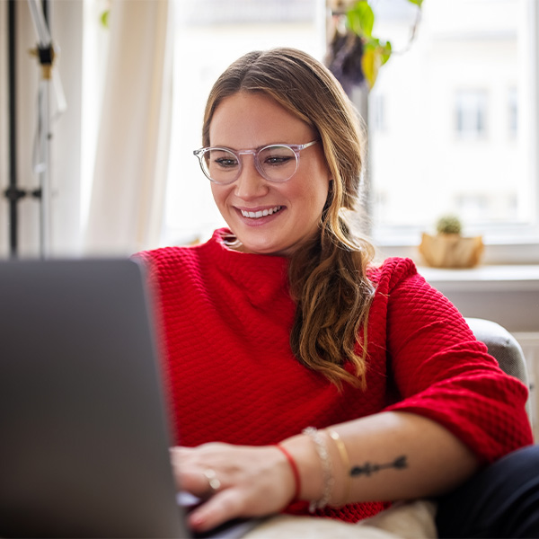Person smiling while on laptop